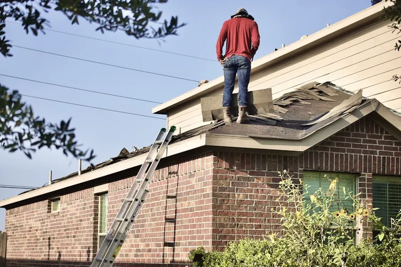 Professional roofer working on a residential roof in Mountain Woods